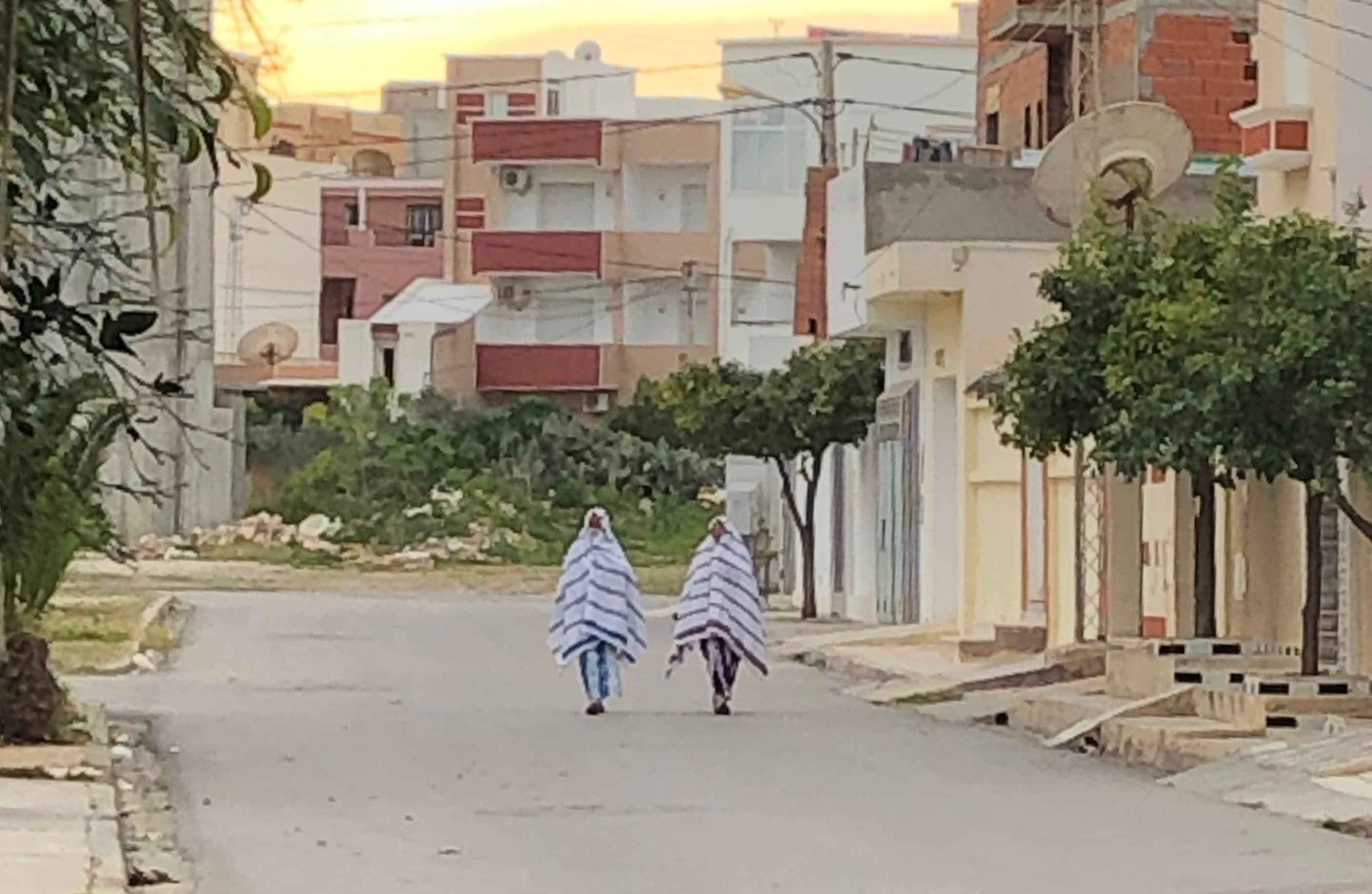 Two women walking through a Tunisian neighborhood